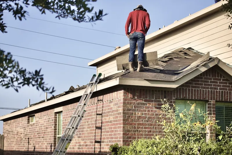 Professional roofer working on a residential roof in Huntcrest Acres